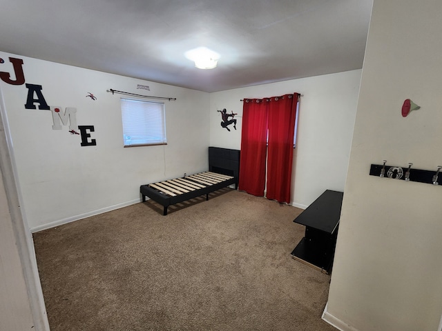 carpeted bedroom featuring baseboards