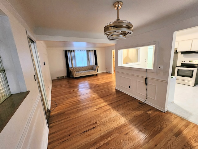 interior space with visible vents, an inviting chandelier, and wood finished floors