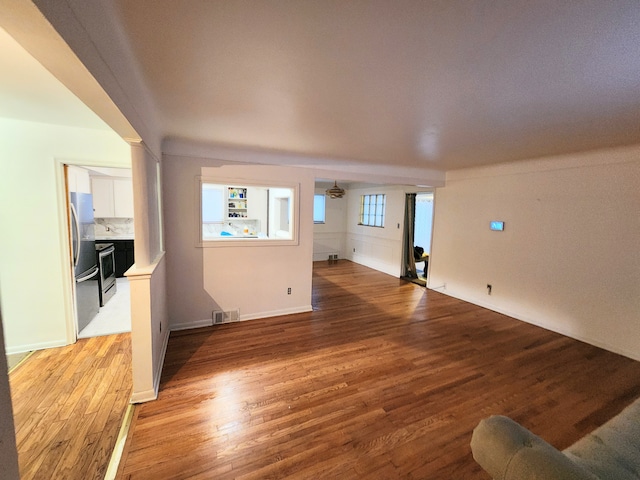 unfurnished living room featuring light wood-style floors and visible vents