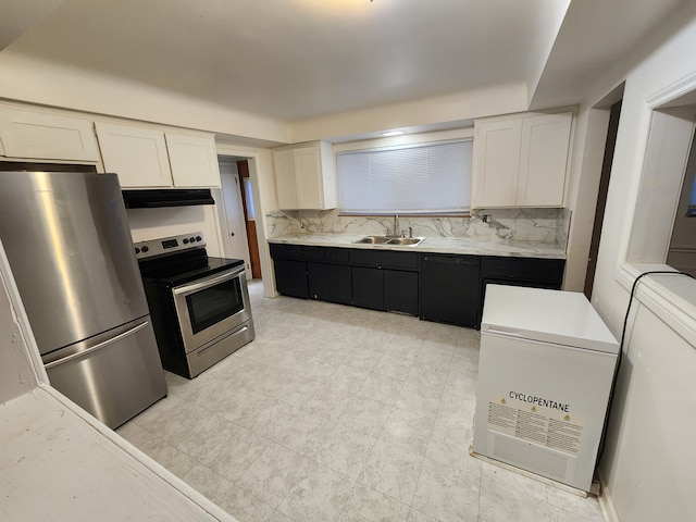 kitchen featuring a sink, light countertops, under cabinet range hood, appliances with stainless steel finishes, and white cabinetry