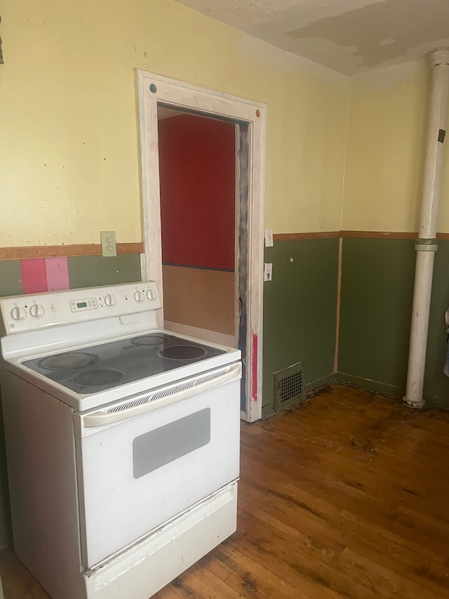 kitchen featuring white range with electric cooktop and wood-type flooring