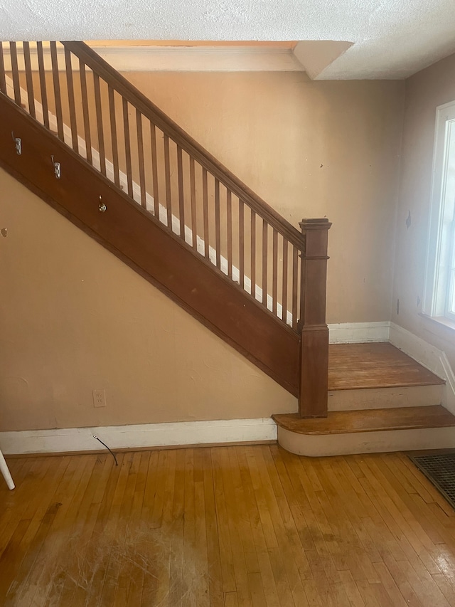 staircase featuring hardwood / wood-style flooring