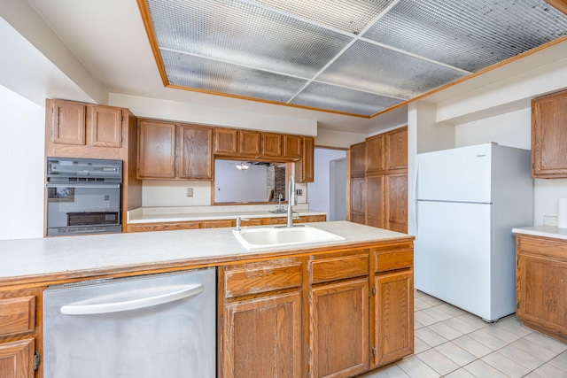 kitchen featuring sink, light tile patterned flooring, oven, white refrigerator, and stainless steel dishwasher