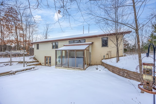 view of snow covered rear of property