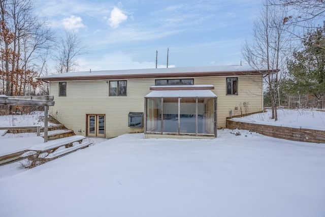 view of snow covered back of property