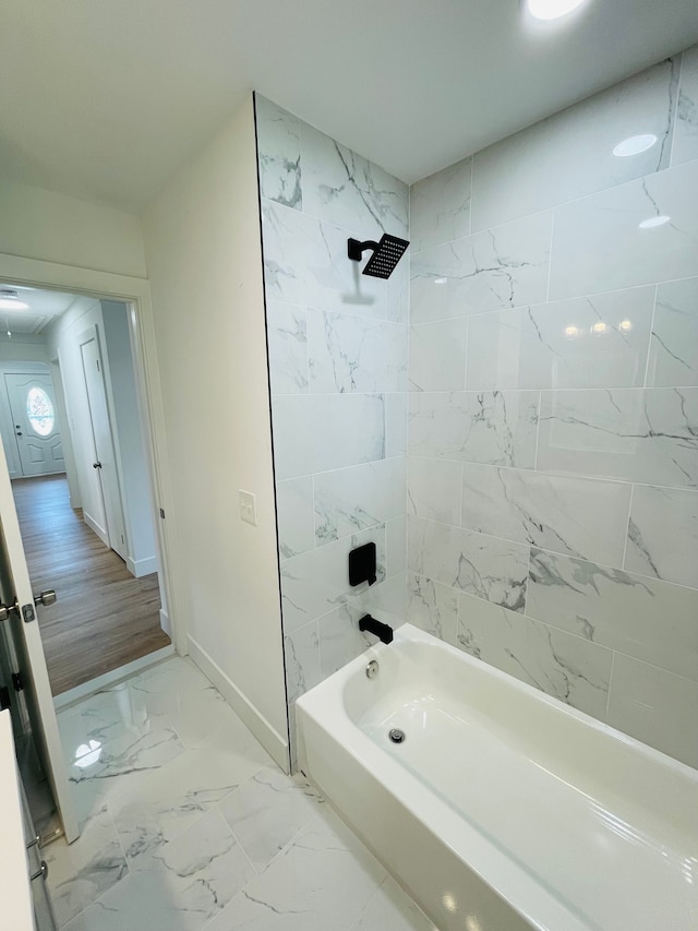 full bath with marble finish floor, shower / bath combination, and baseboards