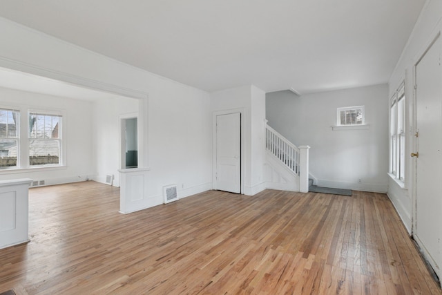 unfurnished living room featuring light hardwood / wood-style floors