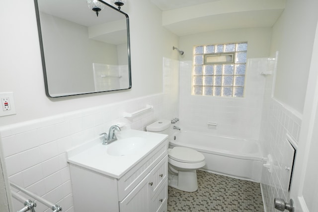 full bathroom with vanity, toilet, shower / washtub combination, and tile walls