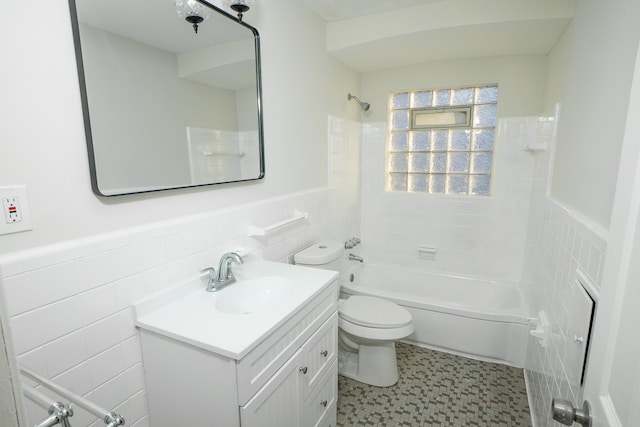 8679 Burt Rd, Detroit, MI 48228 - bathroom with tile walls, vanity, toilet, bathing tub / shower combination, and wainscoting