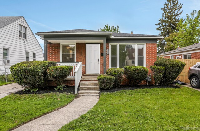 8679 Burt Rd, Detroit, MI 48228 - bungalow featuring brick siding, cooling unit, and roof with shingles