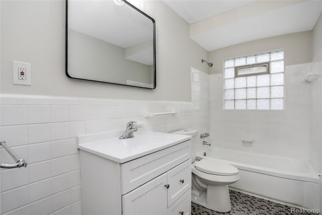 8679 Burt Rd, Detroit, MI 48228 - bathroom with tile walls, bathtub / shower combination, vanity, toilet, and wainscoting