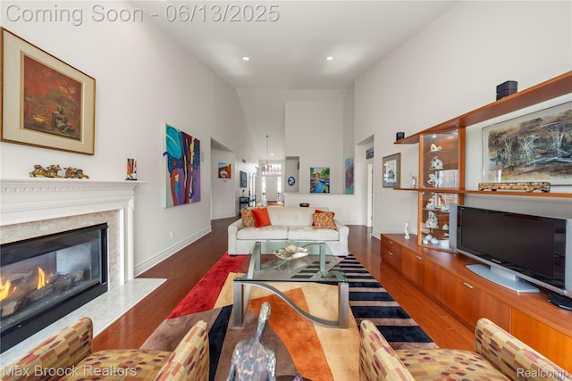 37143 Southwind Ct Unit 38, Farmington Hills, MI 48331 - living area with wood finished floors, a high ceiling, a fireplace, baseboards, and recessed lighting