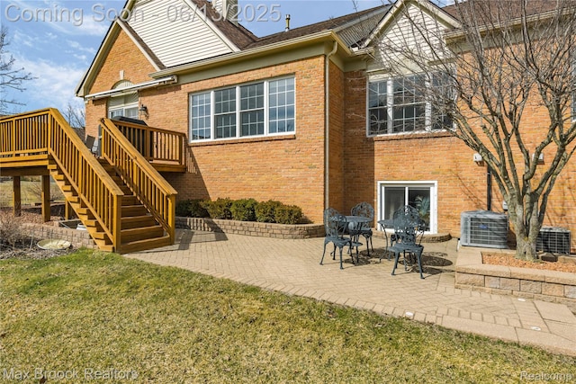 37143 Southwind Ct Unit 38, Farmington Hills, MI 48331 - rear view of property featuring brick siding, stairs, a wooden deck, cooling unit, and a yard