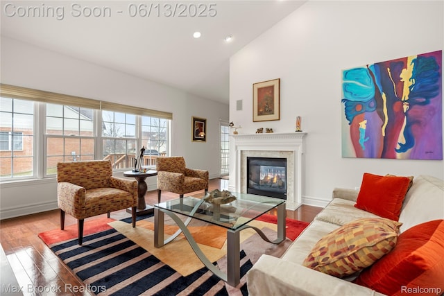 37143 Southwind Ct Unit 38, Farmington Hills, MI 48331 - living room with wood finished floors, recessed lighting, a glass covered fireplace, high vaulted ceiling, and baseboards