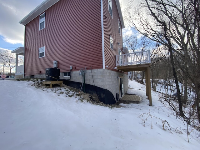 snow covered property featuring a wooden deck