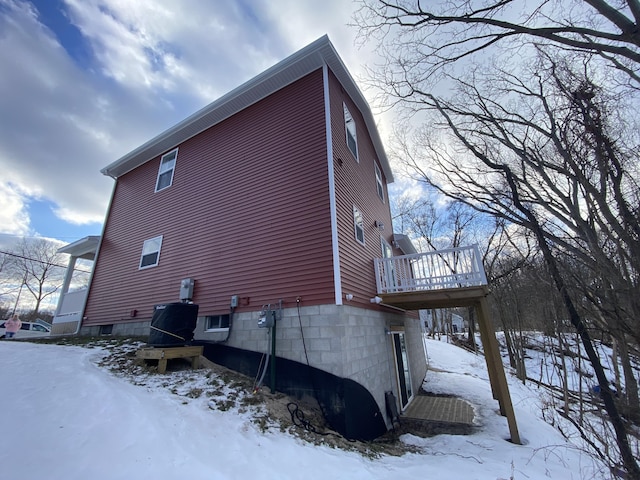 view of snowy exterior featuring a wooden deck