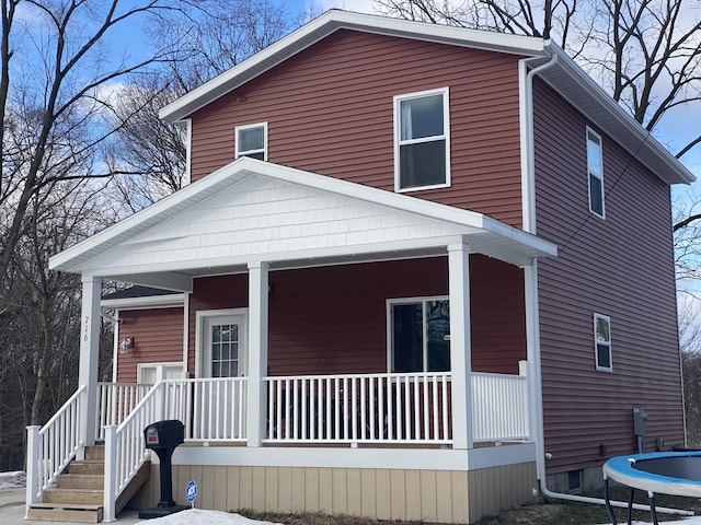 view of front facade featuring covered porch and a trampoline