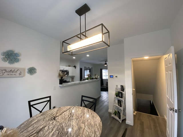 dining space with dark wood-type flooring and ceiling fan