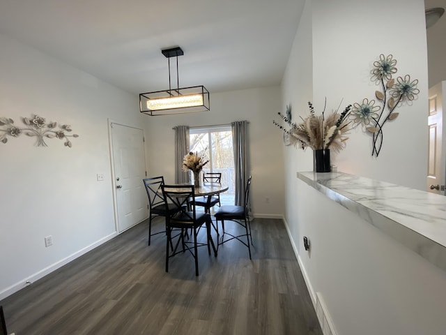 dining area with dark hardwood / wood-style floors