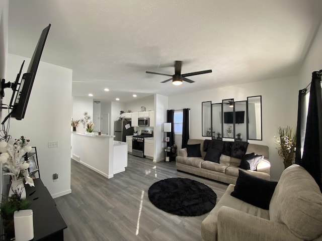 living room with dark wood-type flooring and ceiling fan