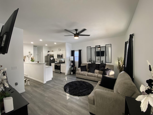 living room with wood-type flooring and ceiling fan