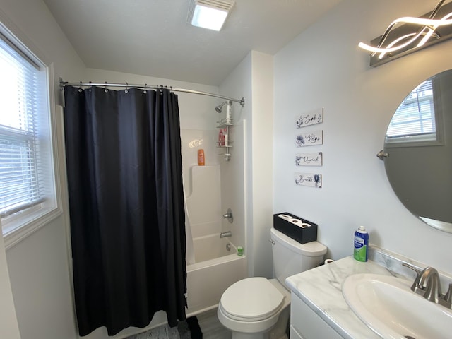 full bathroom with toilet, a healthy amount of sunlight, shower / bathtub combination with curtain, and vanity