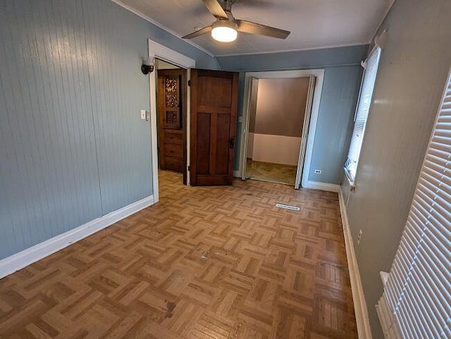 unfurnished bedroom featuring light parquet flooring and ceiling fan