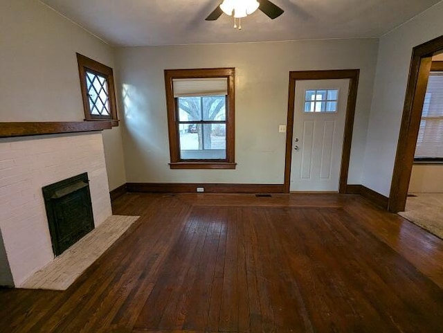 unfurnished living room featuring dark hardwood / wood-style floors and ceiling fan