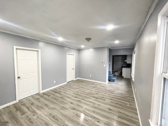 spare room featuring hardwood / wood-style floors and ornamental molding