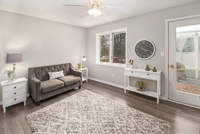 living room featuring dark hardwood / wood-style floors and ceiling fan