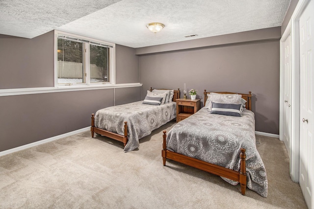 carpeted bedroom featuring a textured ceiling