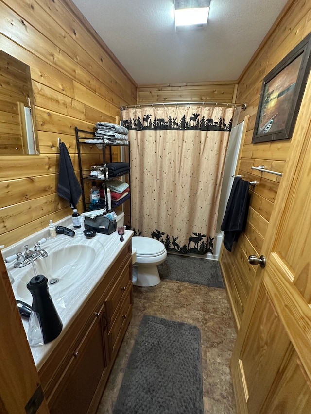 full bathroom with vanity, shower / tub combo, toilet, and wood walls