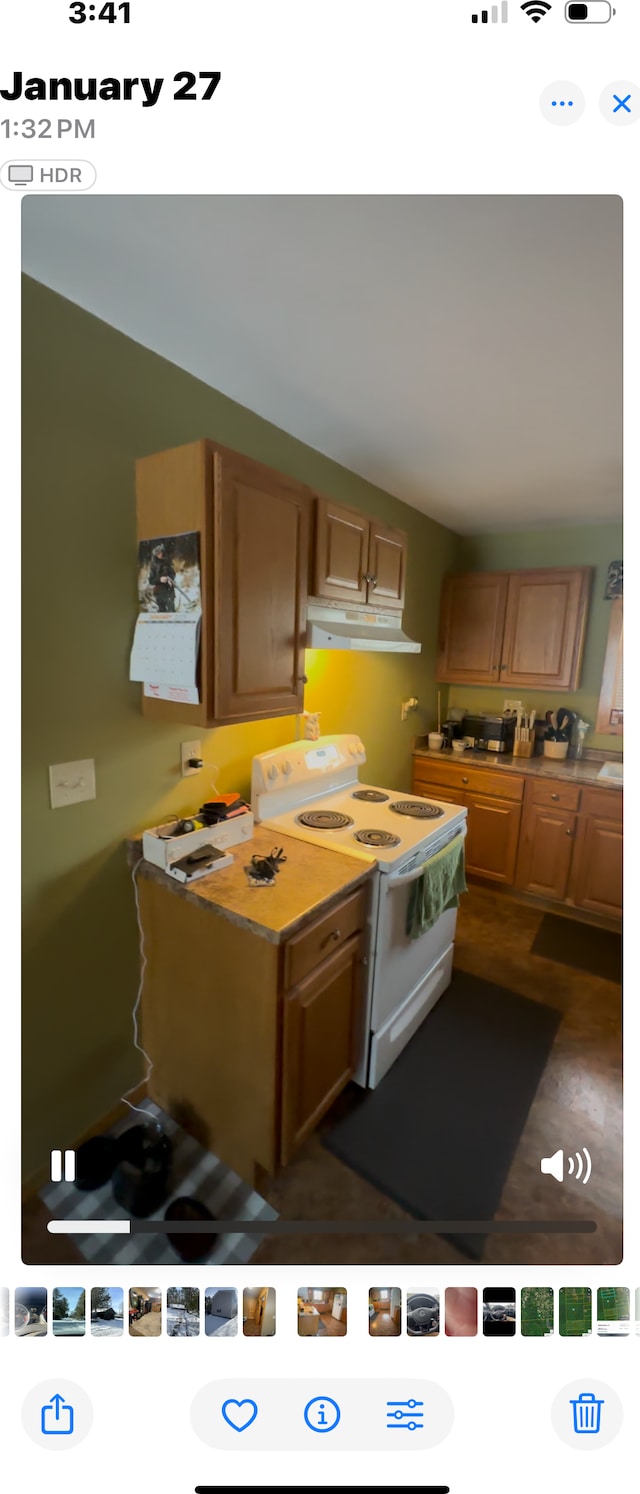 kitchen featuring dark wood-type flooring and white electric range