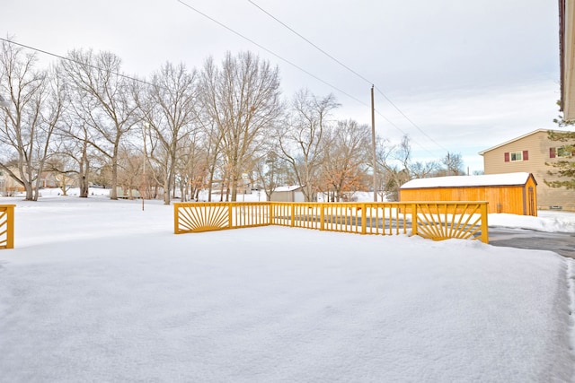 yard layered in snow featuring an outbuilding