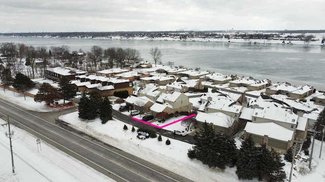 snowy aerial view with a water view