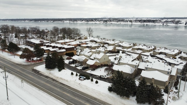 snowy aerial view featuring a water view