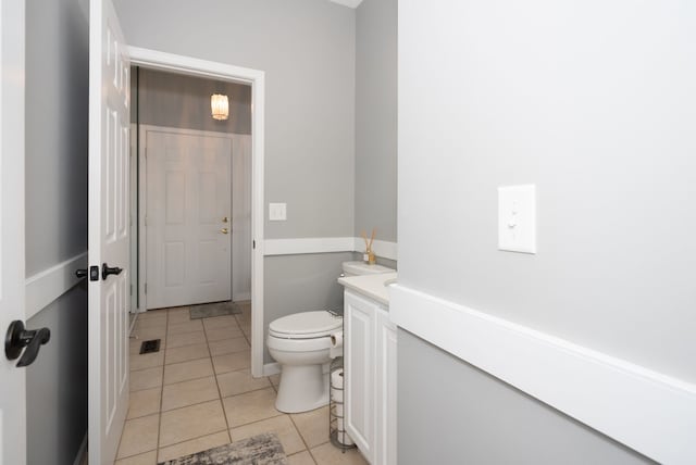 bathroom with vanity, tile patterned flooring, and toilet