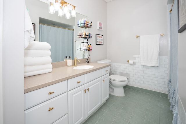 bathroom with tile patterned flooring, vanity, tile walls, and toilet