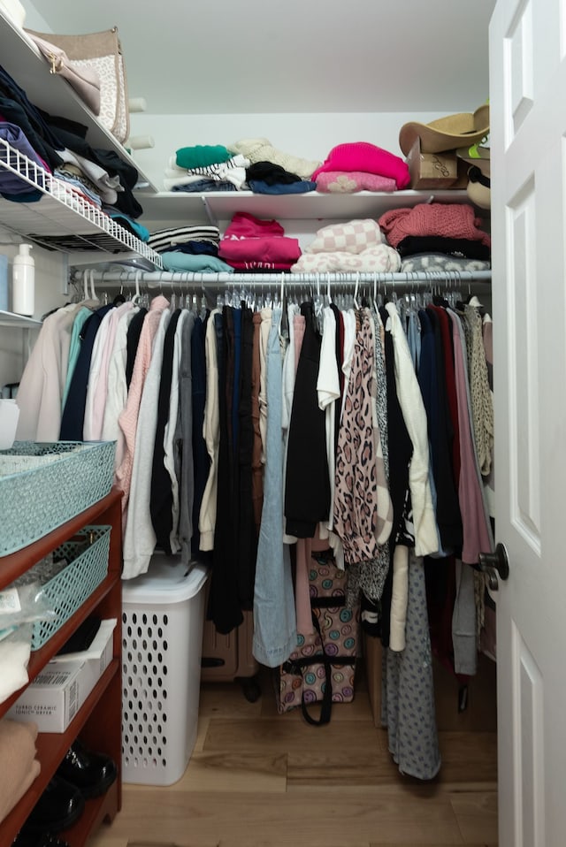 spacious closet with light hardwood / wood-style floors