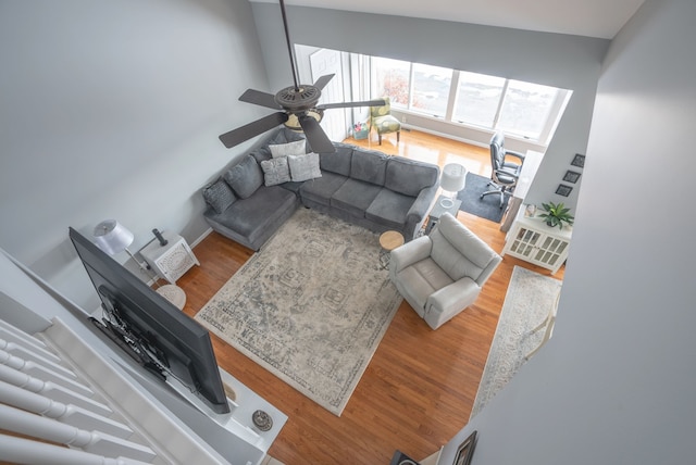 living room featuring hardwood / wood-style floors and ceiling fan