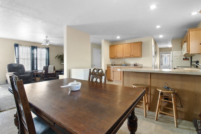 dining room with sink and ceiling fan