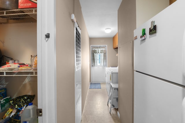 hallway with independent washer and dryer