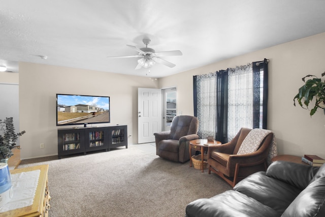 carpeted living room with ceiling fan