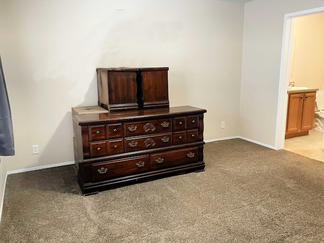 unfurnished bedroom with light colored carpet and ensuite bath