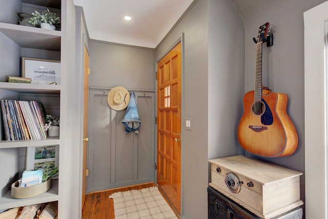 foyer featuring light hardwood / wood-style floors and crown molding