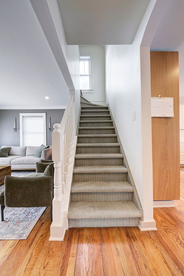 stairs featuring hardwood / wood-style flooring