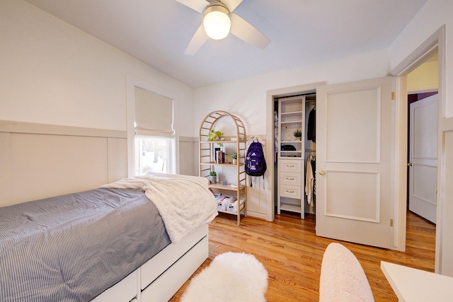 bedroom with ceiling fan, light hardwood / wood-style floors, and a closet