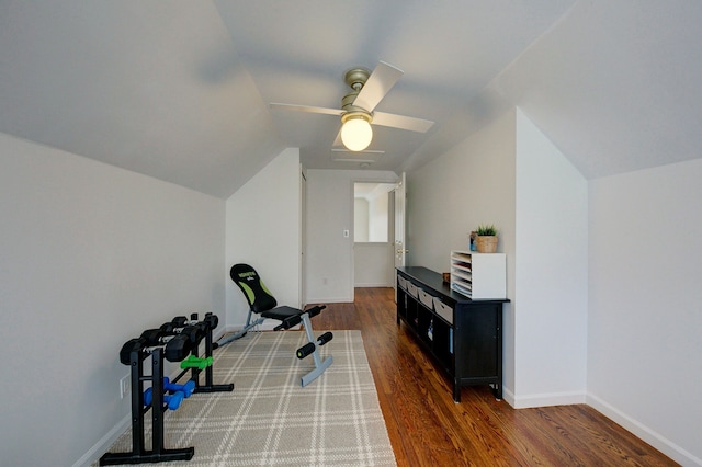 exercise area with vaulted ceiling, dark hardwood / wood-style floors, and ceiling fan