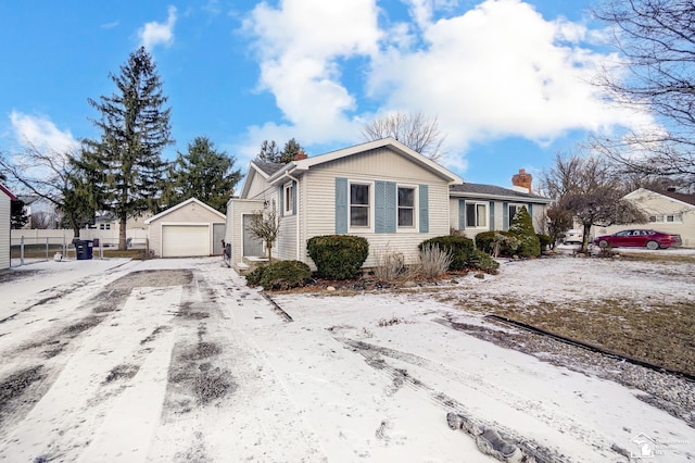 single story home featuring an outbuilding and a garage