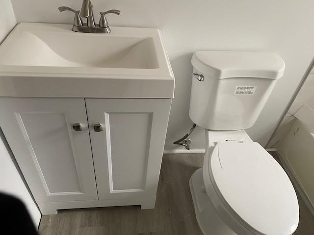 bathroom with vanity, hardwood / wood-style floors, and toilet